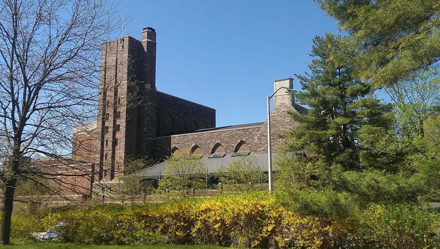 Stone campus building framed by trees at Princeton University