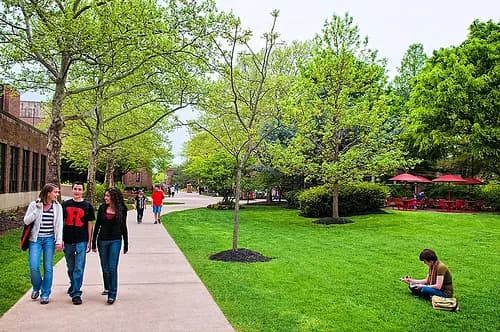Students walking along a tree-lined path on the Rutgers–Camden campus