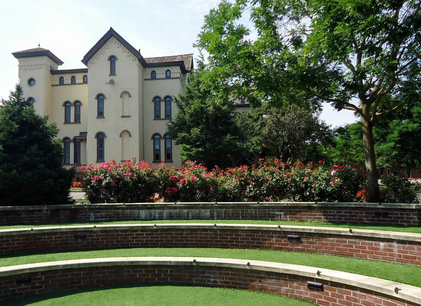 Flower gardens and a historic building on Rutgers’ College Avenue campus