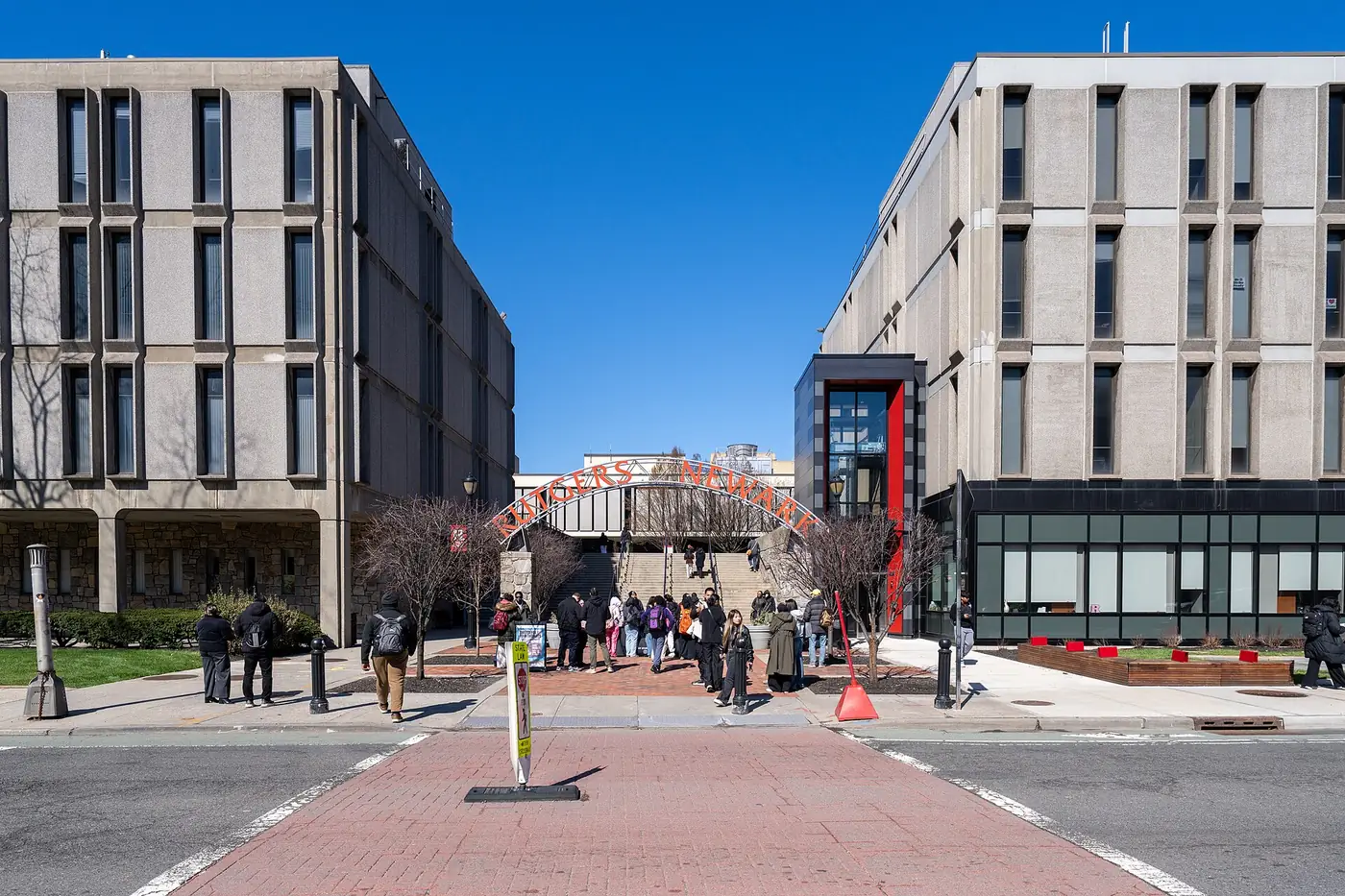 Students near the Rutgers–Newark campus arch between academic buildings