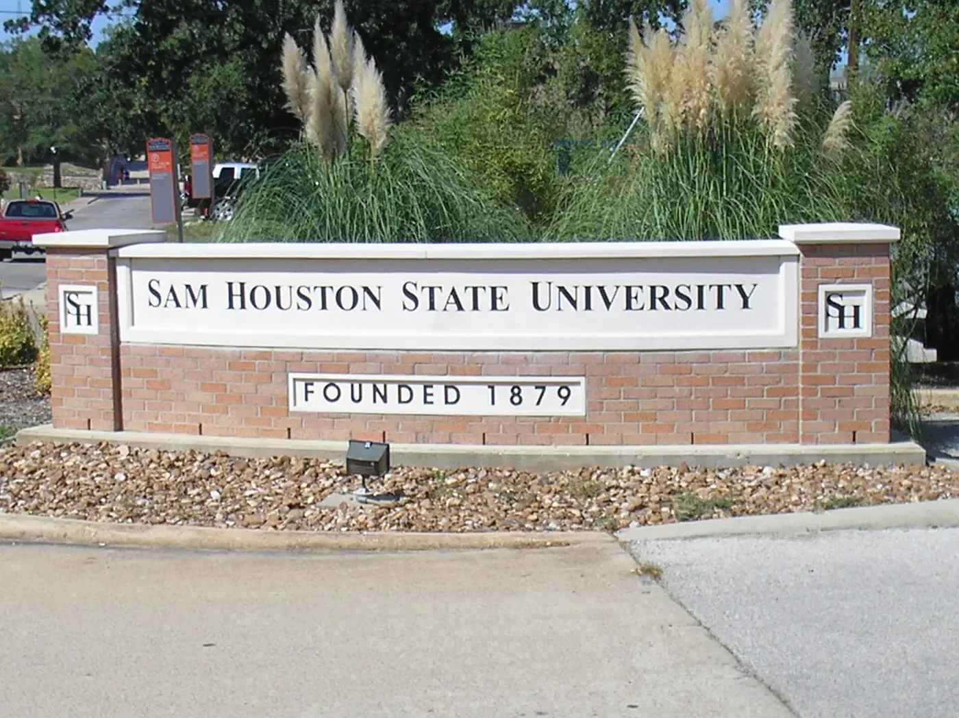 Brick entrance sign reading Sam Houston State University and Founded 1879