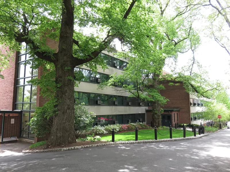 Davis Hall beneath mature trees on the Stevens campus